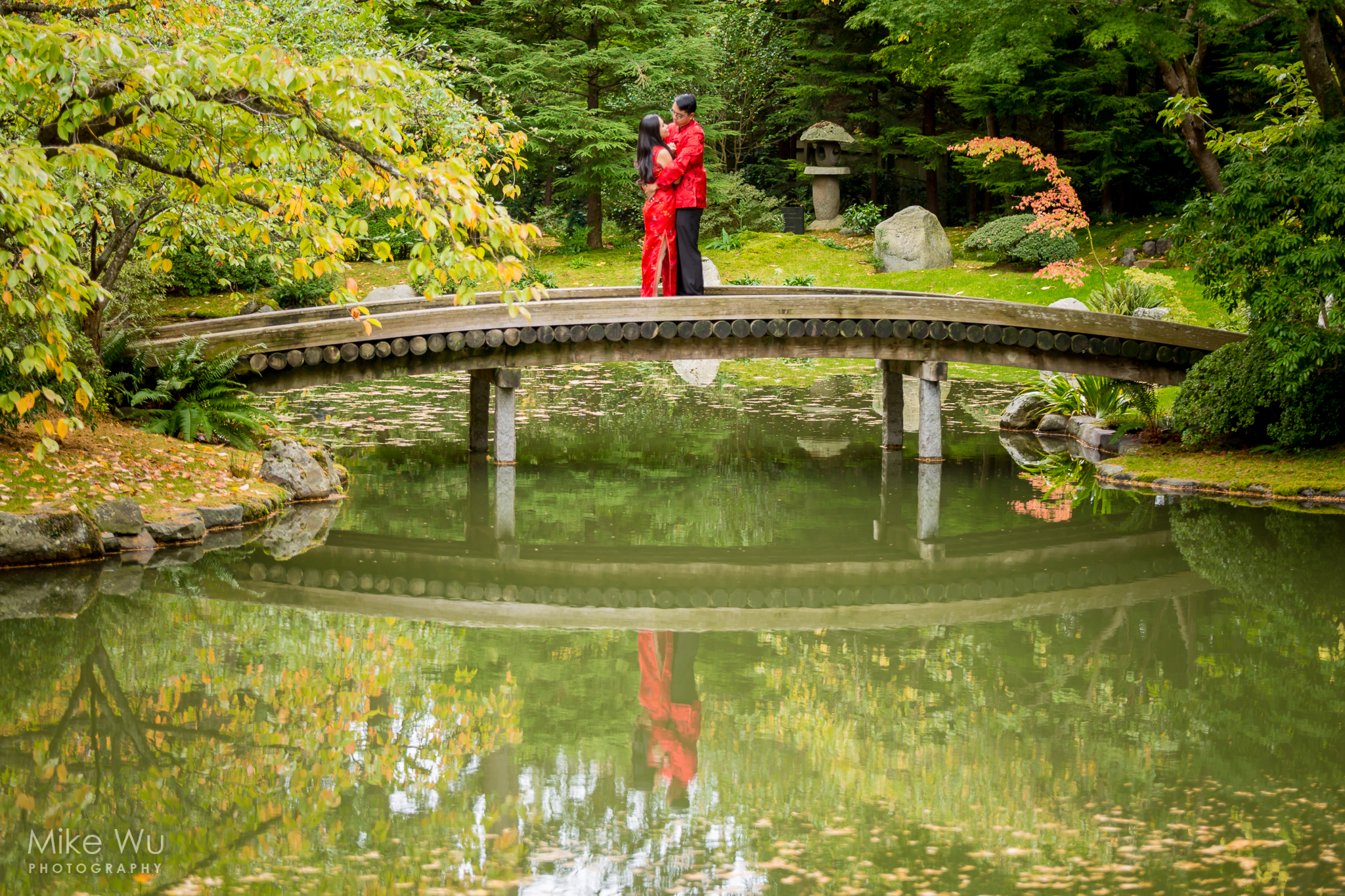 vancouver, engagement, garden, bridge, water, reflection, red, chinese, asian, japanese, beautiful, serene, green, leaves, wedding, couple, love, hug, embrace, together, traditional